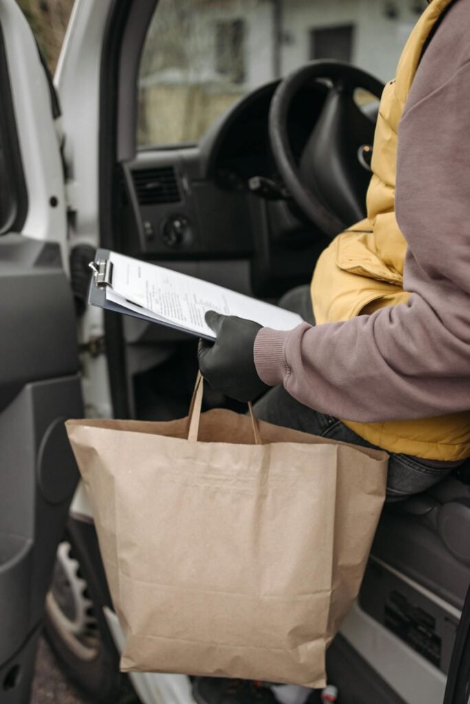 Deliveryman Holding a Clipboard and Paper Bag